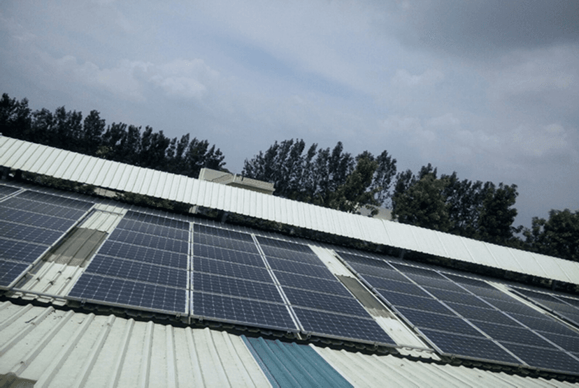 Solar panel installation on residential roof with palm trees